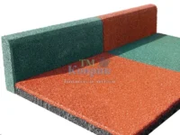 Interlocking foam floor mats in green and orange forming an L-shaped corner.