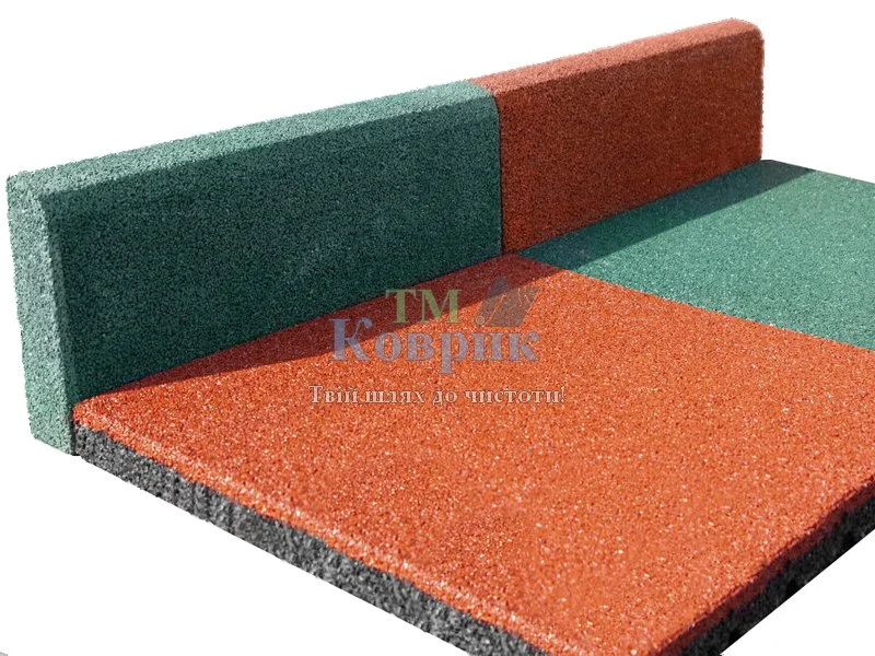 Interlocking foam floor mats in green and orange forming an L-shaped corner.